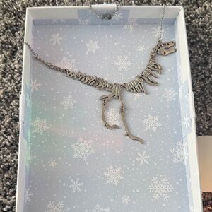 Unique Dinosaur Skeleton Necklace with earrings and ring size 7